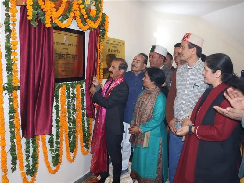 Himachal Pradesh Chief Minister Sukhvinder Singh Sukhu, draped in a pink/red shawl, unveils a bronze commemorative plaque during an inauguration ceremony, surrounded by local dignitaries and officials.