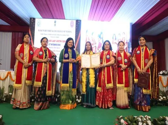 Group of women in traditional Indian attire receiving awards on stage during an event.
