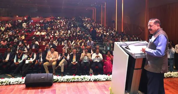 Dr. Jitendra Singh addressing a large audience from a podium at a conference.