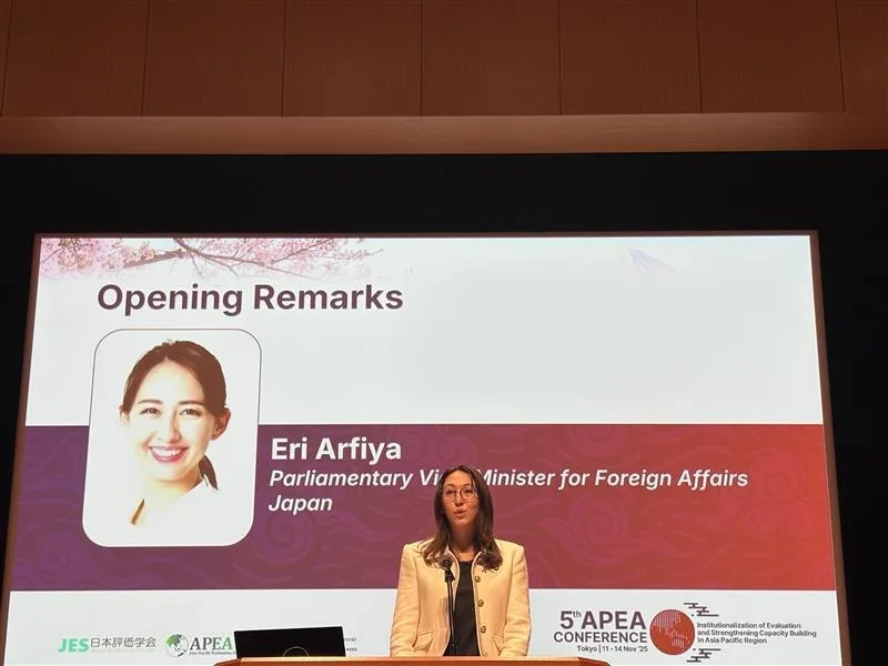Eri Arfiya, Parliamentary Vice Minister for Foreign Affairs of Japan, stands at a podium giving opening remarks at the 5th APEA Conference. A large screen behind her displays her name, title, and a headshot, with "Opening Remarks" at the top.