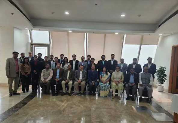 Group photograph of approximately 30-40 participants and dignitaries, including Special Director General, BISAG-N, Sh. Vinay Thakur, and IICA officials, seated and standing in two rows indoors at the session on Digital Governance and Cybersecurity held at the Indian Institute of Corporate Affairs (IICA).