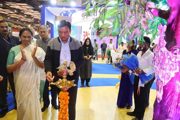 Union Minister Dr. Mansukh Mandaviya lighting a ceremonial lamp at the inauguration of the EPFO Pavilion at IITF 2025, with Union Minister of State Sushree Shobha Karandlaje applauding beside him.