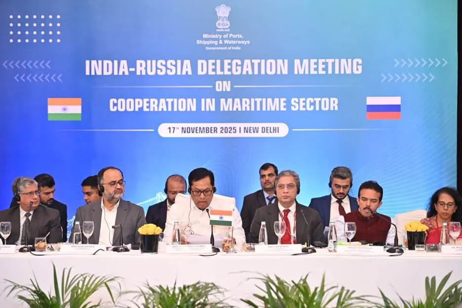 Indian and Russian delegations seated at a long table with a blue backdrop displaying 'India-Russia Delegation Meeting on Cooperation in Maritime Sector