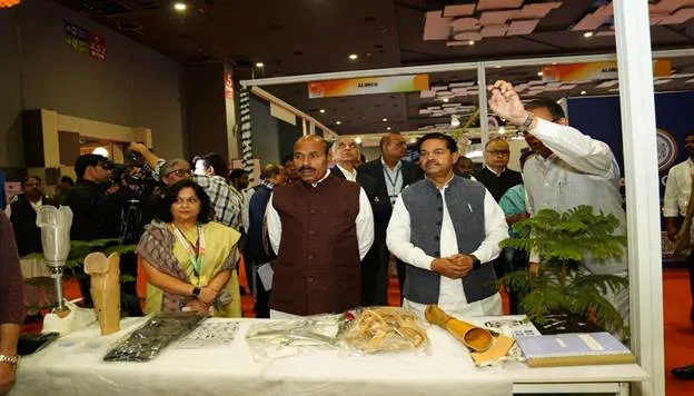 Union Minister Dr. Virendra Kumar and other dignitaries observe products displayed at a stall, likely featuring assistive technologies and crafts by Divyang artisans, during the India International Trade Fair (IITF) 2025.