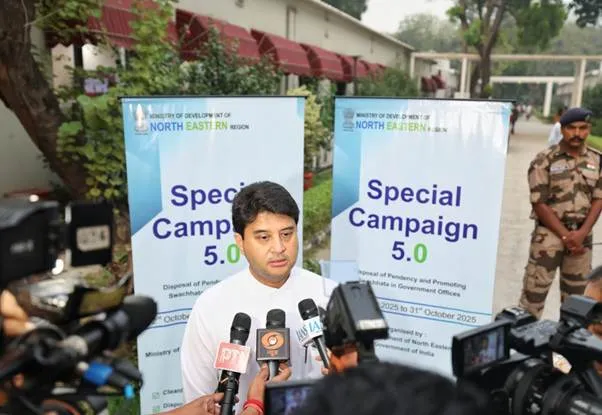 Jyotiraditya Scindia, Union Minister, addresses a press conference in front of 'Special Campaign 5.0' banners, with microphones from various media outlets in front of him and a security personnel standing behind on the right.