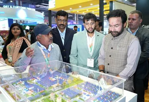 Union Minister G. Kishan Reddy and other officials examine a detailed miniature model of a solar energy project at the Coal India Limited (CIL) pavilion during the India International Trade Fair (IITF) 2025 in New Delhi