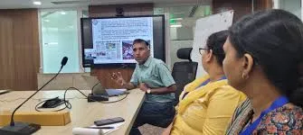 An official from the Office of the Principal Scientific Adviser addresses a meeting with a presentation screen visible in the background discussing the ISTCC.