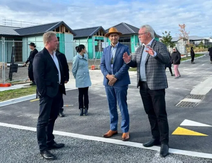 Associate Housing Minister Tama Potaka stands with officials at the Manawa Gardens housing construction site in Rotorua during a tour of the development.