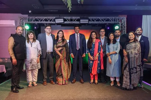 Union Minister Dr Chandra Sekhar Pemmasani poses for a group photograph with members of the Indian diaspora and community leaders on stage in Baku, Azerbaijan.
