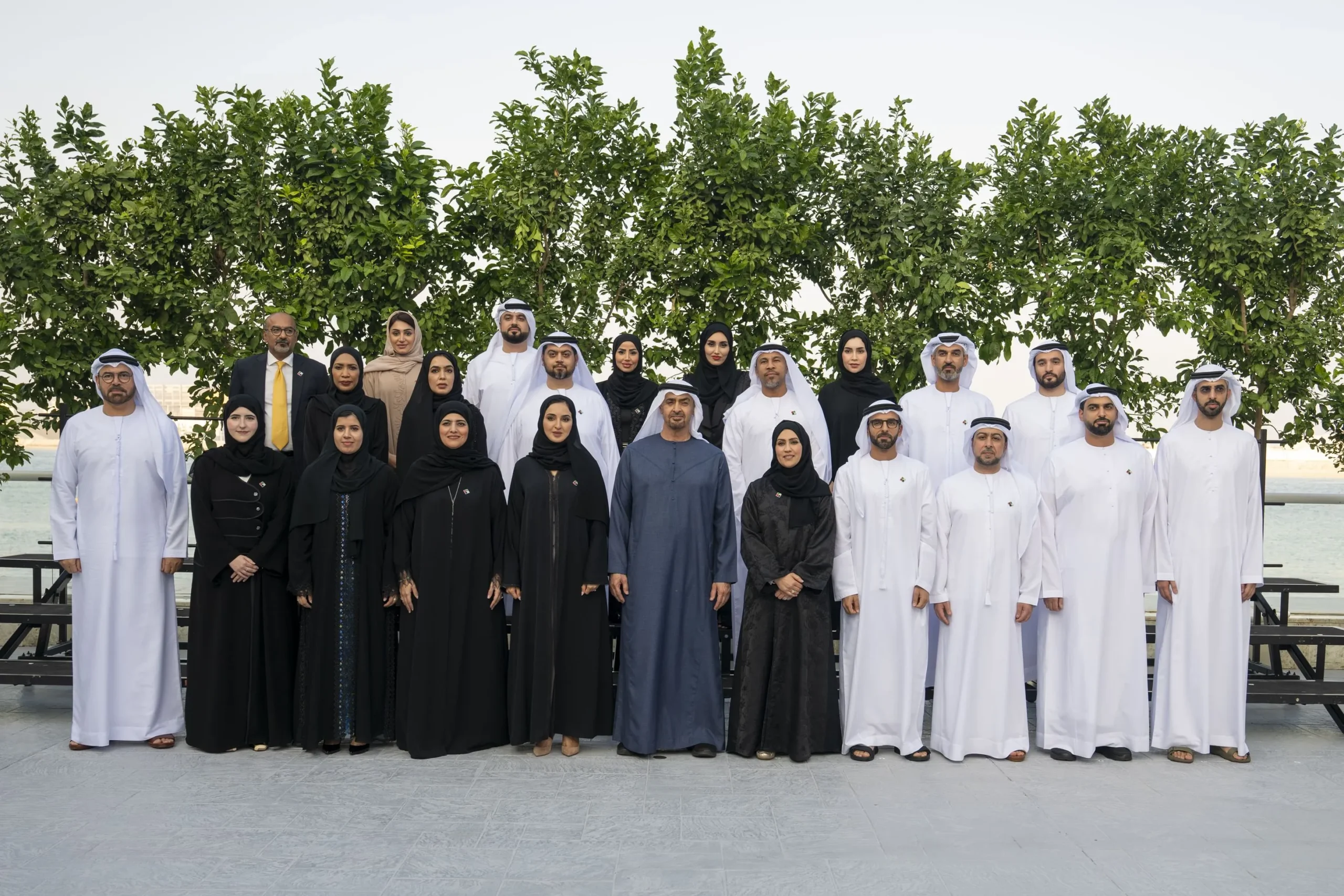 Group photo of UAE President Sheikh Mohamed bin Zayed Al Nahyan standing center with male and female participants of the UAE Government Leaders Programme 2025 outdoors at Qasr Al Bahr.