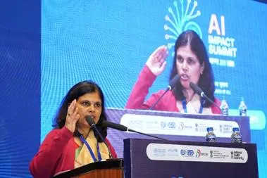 Union Health Secretary Smt. Punya Salila Srivastava addressing the Regional Open Digital Health Summit 2025 in New Delhi with a digital screen displaying AI Impact Summit branding.
