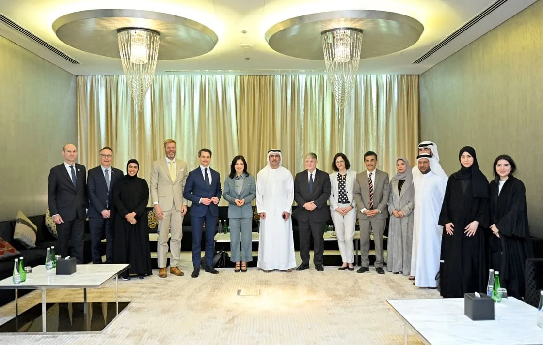 A group of UAE and German officials, including Eng Sharif Al Olama and Katherina Reiche, stand for a group photo in a formal meeting room during the UAE-Germany Energy Forum in Abu Dhabi.