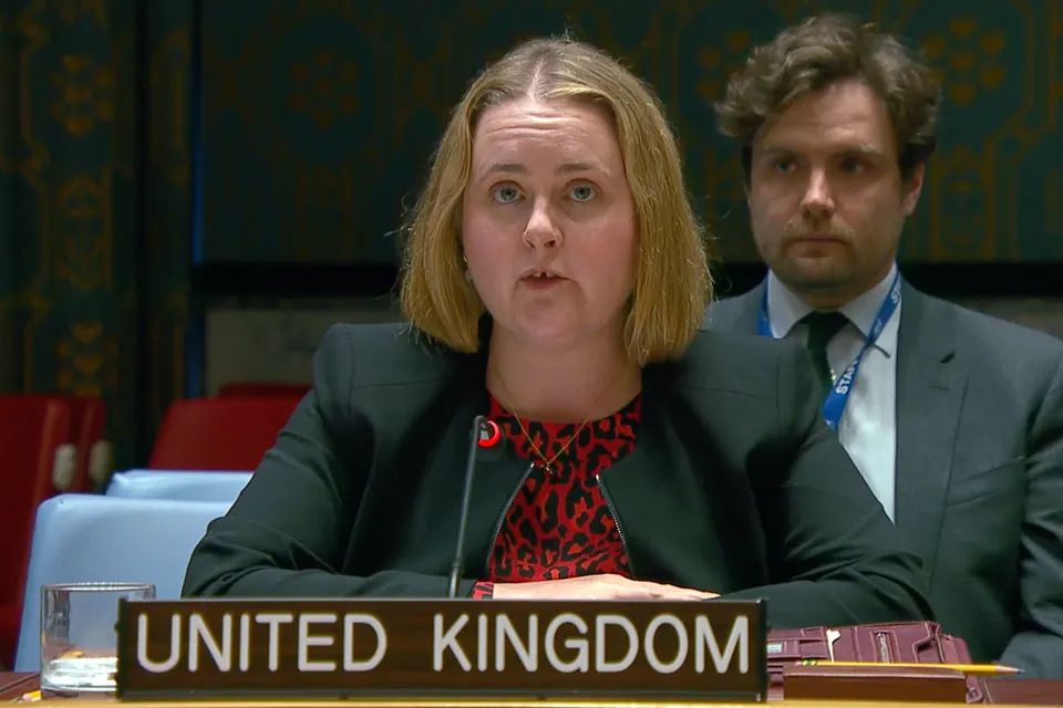 Caroline Quinn, UK Deputy Political Coordinator, speaking behind a United Kingdom placard at the UN Security Council meeting.