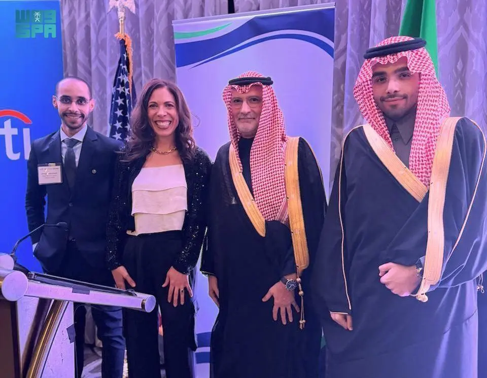 SVC CEO Dr. Nabeel Koshak and Endeavor Catalyst CEO Linda Rottenberg standing with officials in Washington D.C. with Saudi and American flags in the background.