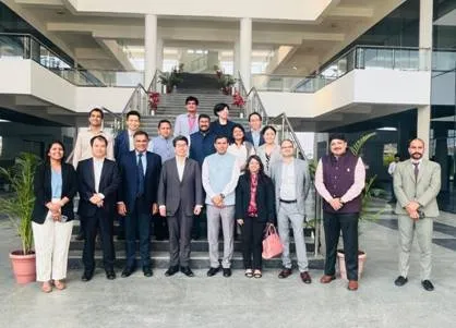 JBIC Governor Nobumitsu Hayashi and delegation members pose with NICDC and DICDL officials on the staircase of the ABCD Building at Dholera SIR, Gujarat.