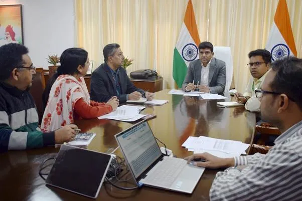 Union Minister of State Dr Pemmasani Chandra Sekhar chairs a high-level review meeting with Department of Posts officials in a conference room featuring Indian flags, discussing revenue leakage and digital security measures.