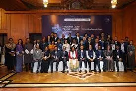 Group photo of health leaders and delegates standing on stage in front of a banner at the Regional Open Digital Health Summit 2025 in New Delhi.