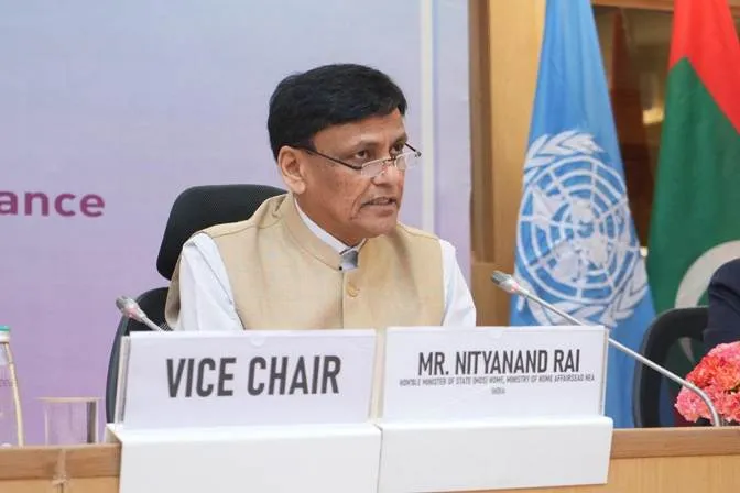 Minister of State Nityanand Rai sitting at the Vice Chair desk addressing the 10th APDIM session in New Delhi with UN and Maldives flags in the background.