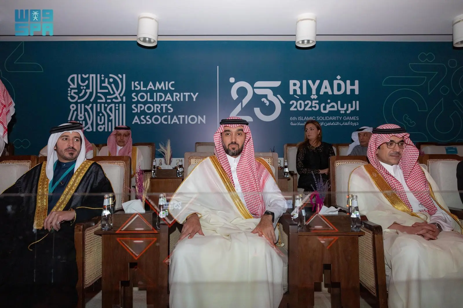 Saudi Minister of Sport Prince Abdulaziz bin Turki bin Faisal seated centrally with Prince Fahd bin Jalawi and officials during the closing ceremony of the 6th Islamic Solidarity Games "Riyadh 2025", featuring the event logo in the background.