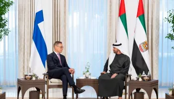 President Alexander Stubb of Finland and UAE President Sheikh Mohamed bin Zayed Al Nahyan seated in armchairs during a formal meeting in Abu Dhabi, with the flags of Finland and the United Arab Emirates displayed in the background.