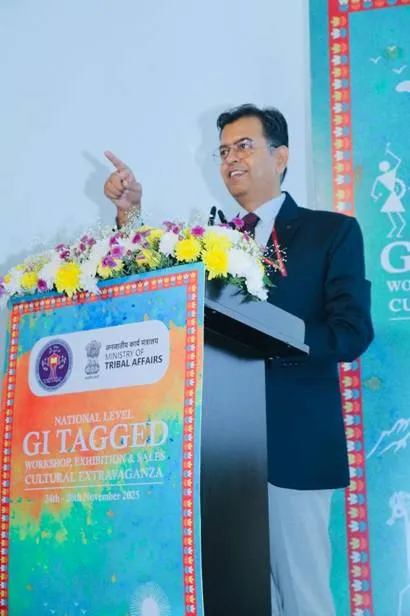 Shri Ajeet Kumar Srivastava, Commissioner of NESTS, speaking at a podium during the inauguration of the National Level GI Tagged Tribal Art Workshop and Exhibition in New Delhi.