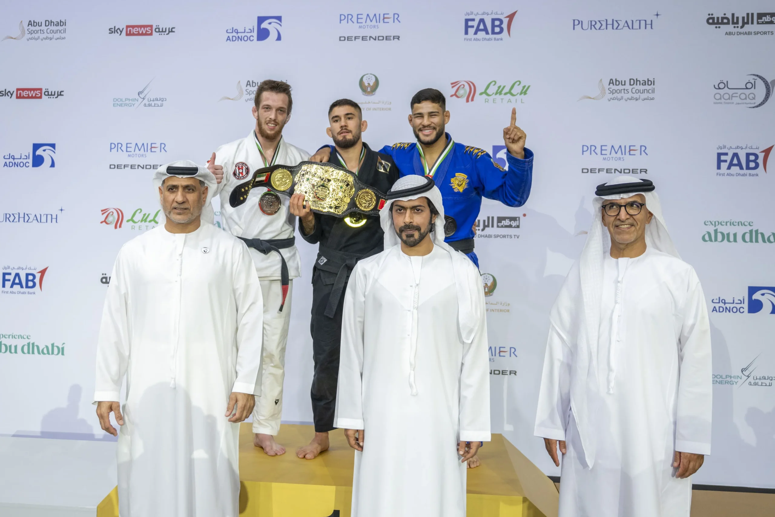 Sheikh Khalifa bin Tahnoon bin Mohammed Al Nahyan poses with black belt medalists on the podium during the closing ceremony of the 17th Abu Dhabi World Professional Jiu-Jitsu Championship.