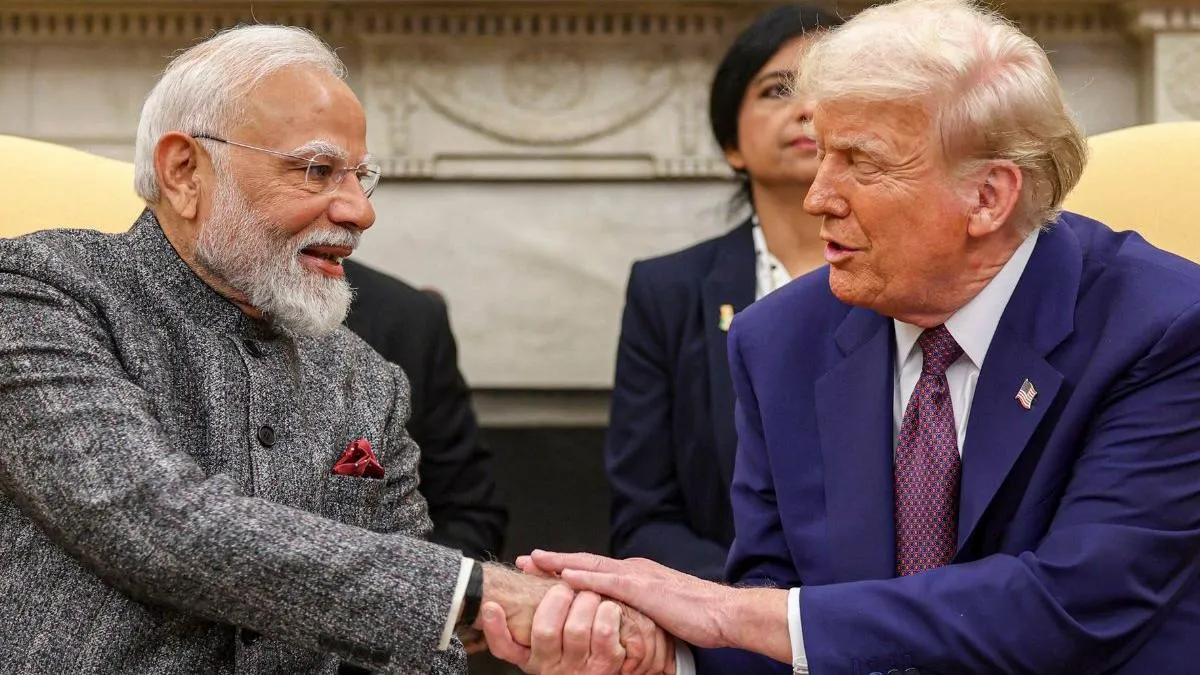 Indian Prime Minister Narendra Modi shaking hands with US President Donald Trump while seated during a diplomatic meeting.