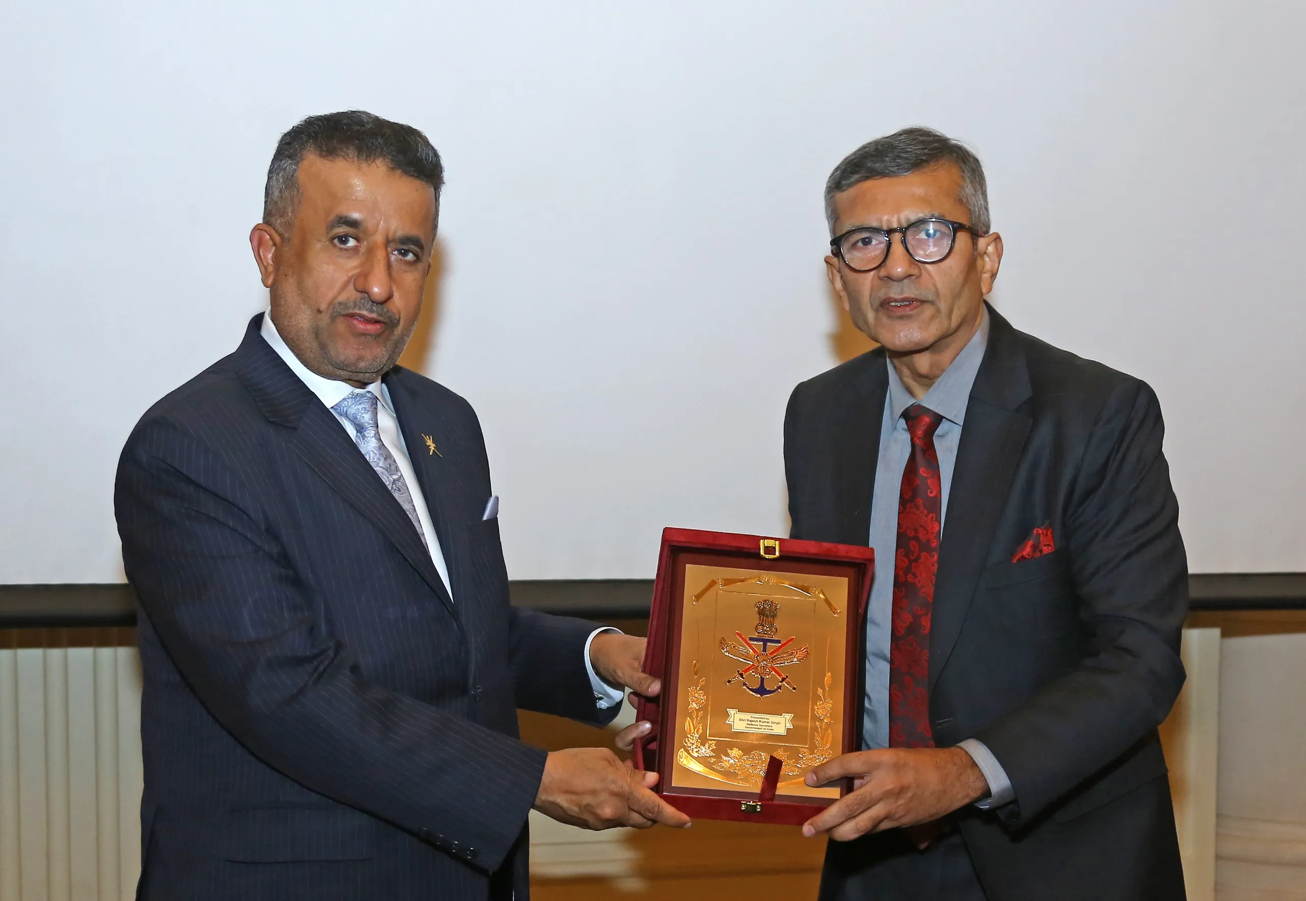 Indian Defence Secretary Shri Rajesh Kumar Singh (right) presents a commemorative plaque to Dr. Mohammed Bin Naseer Bin Ali Al Zaabi, Secretary General, Ministry of Defence, Oman (left), during the 13th Joint Military Cooperation Committee meeting in New Delhi.