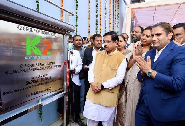 Union Minister Pralhad Joshi standing next to the inauguration plaque for the K2 Biofuels Private Limited biomass pellet plant in Rewari, Haryana, on November 25, 2025