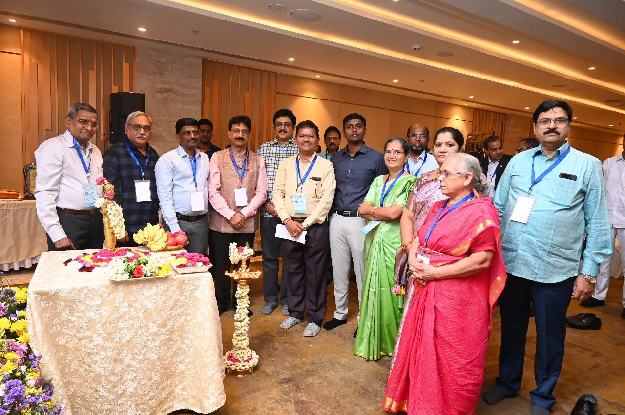 Group photograph of dignitaries and delegates including Prof. Vd. Rabinarayan Acharya (Director General, CCRAS), Dr N. Srikanth, Shri K. Dinesh Kumar IAS, and industry representatives at the inaugural ceremony of SIDDHI 2.0 national conclave on Ayurveda research and innovation held in Vijayawada, with traditional lamp and offerings in the foreground.