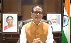Union Agriculture Minister Shivraj Singh Chouhan seated in an official chair with portraits of Prime Minister Narendra Modi and former President Draupadi Murmu in the background and the Indian national flag on the right.