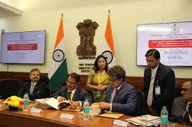 Officials from DHTI, NADT Nagpur and VVGNLI Noida signing MoUs at a formal ceremony in South Block, New Delhi on November 26, 2025, with the Indian national emblem and flag in the background.