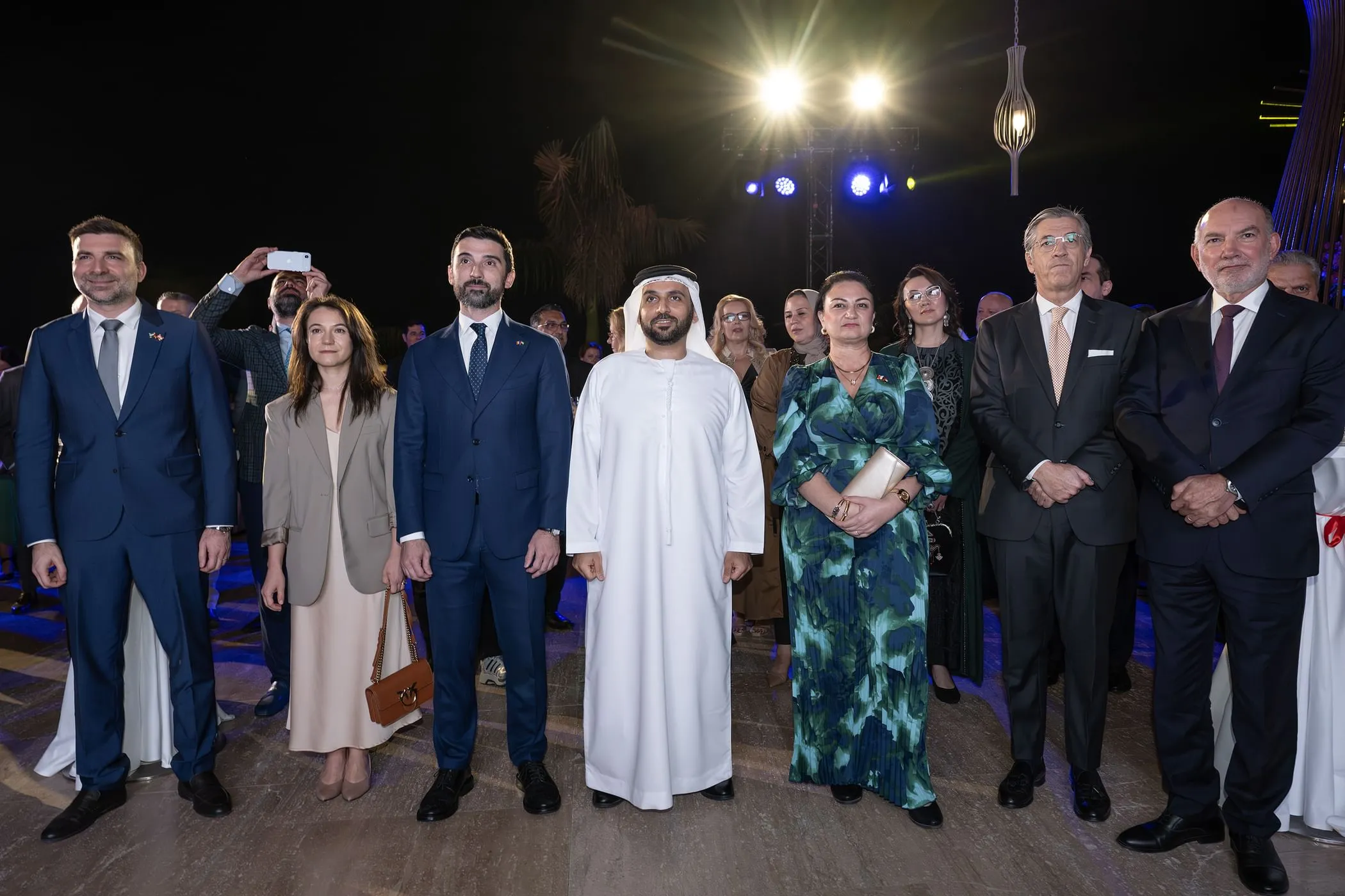 Group photo at the Romanian National Day reception in Abu Dhabi featuring Ambassador Bogdan Octavian Badica, Sheikh Omar Rashid Al Neyadi, and members of the diplomatic corps at the Grand Hyatt Abu Dhabi.