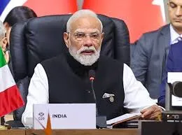 Indian Prime Minister Narendra Modi seated at the conference table during the 60th All India Conference of Director Generals/Inspector Generals of Police in Raipur, Chhattisgarh, November 2025, with a nameplate reading "INDIA" in front of him.