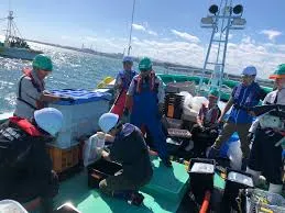 IAEA officials and international experts from third-party laboratories collect seawater and marine samples from a fishing vessel off the coast of Fukushima Prefecture, Japan, as part of the December 2025 monitoring mission for ALPS treated water discharge.