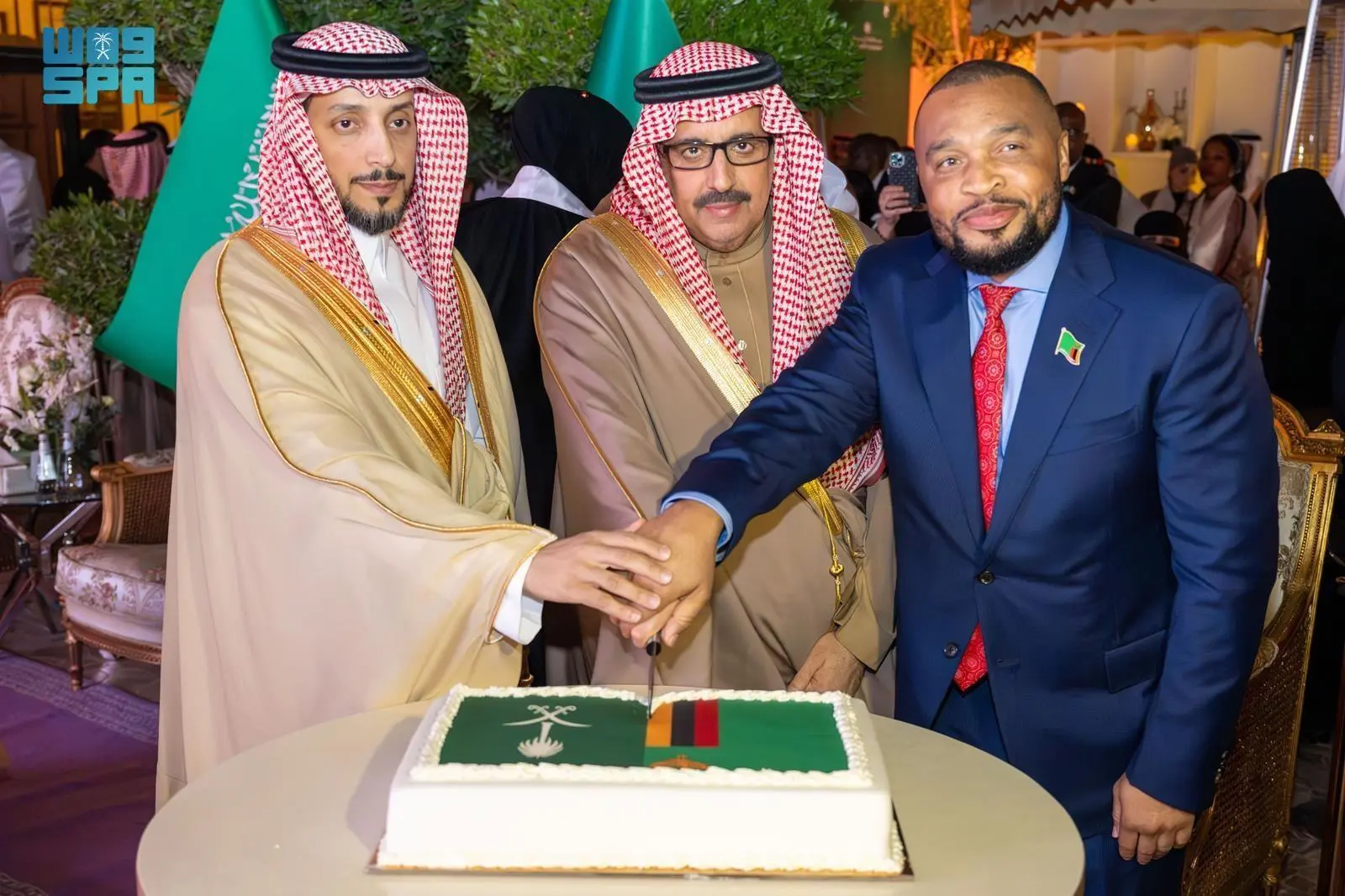 Saudi Arabia's Undersecretary of Riyadh Principality Dr. Faisal bin Abdulaziz Al-Sudairy and Zambian Ambassador Duncan Mulima jointly cut a cake featuring the flags of Saudi Arabia and Zambia during Zambia's National Day celebration at the Zambian Embassy in Riyadh.